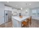 Well-lit kitchen with stainless steel appliances, white cabinets, and large island with chairs at 2270 Kemmerlin St, Johns Island, SC 29455