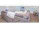 Bright living room with a plush sofa, wood floors, and a TV displaying a beach scene at 2270 Kemmerlin St, Johns Island, SC 29455