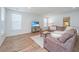 Bright living room featuring a large sofa, wood floors, and ample natural light at 2270 Kemmerlin St, Johns Island, SC 29455