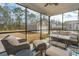 Screened-in patio with wicker furniture and a view of the detached garage and backyard at 2270 Kemmerlin St, Johns Island, SC 29455