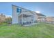 Backyard featuring a screened-in porch with furniture, grill, and a wide expanse of grassy lawn at 232 Decatur Dr, Summerville, SC 29486