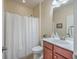 Bathroom with a shower with a white shower curtain, a toilet, a mirror, and a vanity with wood cabinets at 232 Decatur Dr, Summerville, SC 29486