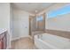 Bright bathroom with a soaking tub, tiled shower, and neutral color palette at 232 Decatur Dr, Summerville, SC 29486
