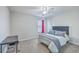 Bedroom featuring neutral carpet, a bed with gray comforter, desk, and window with pink curtain at 232 Decatur Dr, Summerville, SC 29486
