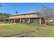 Spacious outdoor clubhouse with a fireplace and ample seating overlooking the lush lawn at 232 Decatur Dr, Summerville, SC 29486