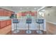 An open kitchen featuring granite countertops, bar stool seating at the kitchen island, and dark wood cabinets at 232 Decatur Dr, Summerville, SC 29486