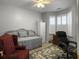 Neutral bedroom with a day bed and a work space including a rolling office chair and shuttered windows at 2419 Tuscany Dr, North Charleston, SC 29406