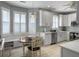 Charming kitchen features white cabinetry, stainless steel appliances, and an adjacent breakfast nook at 2419 Tuscany Dr, North Charleston, SC 29406