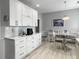 Bright kitchen featuring white cabinets, a cozy eat-in area, and updated countertops at 2419 Tuscany Dr, North Charleston, SC 29406