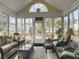 Bright sunroom boasting vaulted ceilings, multiple seating areas, and large windows offering plenty of light at 2419 Tuscany Dr, North Charleston, SC 29406