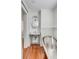 Bathroom with a freestanding sink, soaking tub, hardwood floors, and clean design at 25 Logan St, Charleston, SC 29401