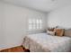 Bedroom with shutters, hardwood floors, and neutral decor at 25 Logan St, Charleston, SC 29401