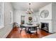 Bright dining room features fireplace, chandelier, and open access to kitchen at 25 Logan St, Charleston, SC 29401