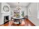 Elegant dining room boasting a fireplace, chandelier, and hardwood floors at 25 Logan St, Charleston, SC 29401