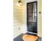 The black front door features a half-glass window and a charming exterior light at 25 Logan St, Charleston, SC 29401