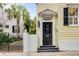 Stylish black front door with the number 25, sidelights, and a small porch at 25 Logan St, Charleston, SC 29401