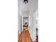 Bright hallway with hardwood floors, white walls, and open doorways leading to other rooms at 25 Logan St, Charleston, SC 29401