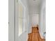 Hallway featuring hardwood floors, white walls, and doors leading to various rooms at 25 Logan St, Charleston, SC 29401