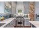 Kitchen featuring an island cooktop, stainless steel range, and marble countertops at 25 Logan St, Charleston, SC 29401