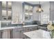 Bright kitchen with marble countertops, stainless steel sink, and light-grey cabinets at 25 Logan St, Charleston, SC 29401