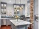 Well-lit kitchen features a large island, stainless steel appliances, and grey cabinets at 25 Logan St, Charleston, SC 29401