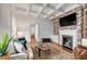 Comfortable living room featuring a brick fireplace, coffered ceiling and stylish furniture at 25 Logan St, Charleston, SC 29401