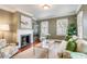 Cozy living room with a fireplace, hardwood floors, and lots of natural light at 25 Logan St, Charleston, SC 29401