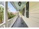 Charming front porch with black floors, painted ceilings, and decorative lighting at 25 Logan St, Charleston, SC 29401