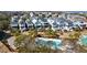 Aerial view of a neighborhood with a community pool, palm trees, and well-maintained homes at 27 Ocean Point Dr, Isle of Palms, SC 29451