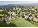 Aerial view of a golf course community surrounded by lush greenery, beautiful homes, and picturesque fairways at 27 Ocean Point Dr, Isle of Palms, SC 29451