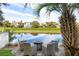 Scenic backyard featuring a seating area with a fire pit overlooking a serene waterway and golf course at 27 Ocean Point Dr, Isle of Palms, SC 29451