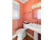 Charming powder room features decorative wallpaper, a pedestal sink, and elegant fixtures at 27 Ocean Point Dr, Isle of Palms, SC 29451