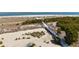Aerial view of a sandy beach with a wooden walkway and lush vegetation near the ocean at 27 Ocean Point Dr, Isle of Palms, SC 29451