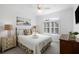 Comfortable bedroom with shuttered window for privacy and soft, natural light at 27 Ocean Point Dr, Isle of Palms, SC 29451