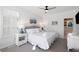 Bright bedroom featuring a comfortable bed, shuttered windows, and serene beach-themed artwork at 27 Ocean Point Dr, Isle of Palms, SC 29451