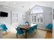 Bright dining area with large window and seating for eight, with a hardwood floor and area rug at 27 Ocean Point Dr, Isle of Palms, SC 29451