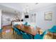 A large dining room with an open kitchen, seating for eight, hardwood floors and bright decor at 27 Ocean Point Dr, Isle of Palms, SC 29451