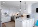 Modern kitchen featuring white cabinets, stainless steel appliances, and a spacious quartz countertop at 27 Ocean Point Dr, Isle of Palms, SC 29451