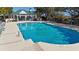 Sparkling community pool with ample lounge seating and a covered pavilion for relaxing at 27 Ocean Point Dr, Isle of Palms, SC 29451