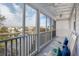 Screened-in porch featuring rocking chairs and views of the lake at 27 Ocean Point Dr, Isle of Palms, SC 29451