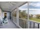 Screened-in porch featuring rocking chairs and views of the lake at 27 Ocean Point Dr, Isle of Palms, SC 29451