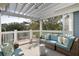 Cozy covered porch with comfortable seating and serene views of the neighborhood at 27 Ocean Point Dr, Isle of Palms, SC 29451
