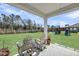 Covered patio with outdoor seating overlooking the backyard at 3213 Great Egret Dr, Johns Island, SC 29455