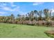 Spacious fenced backyard with a waterfront view and lush green grass at 3213 Great Egret Dr, Johns Island, SC 29455