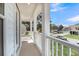 Relaxing covered balcony featuring white columns and a seating area with neighborhood views at 3213 Great Egret Dr, Johns Island, SC 29455