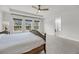 Bright bedroom featuring large windows, a ceiling fan, and an ensuite bathroom for convenience at 3213 Great Egret Dr, Johns Island, SC 29455