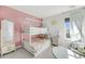 Charming bedroom with a white bunk bed, soft rug, whimsical decor and pretty pastel accents at 3213 Great Egret Dr, Johns Island, SC 29455