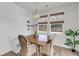Cozy dining area showcases a wooden table, woven chairs, and natural light from large windows at 3213 Great Egret Dr, Johns Island, SC 29455