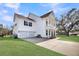 Side view showing the house, driveway, a backyard tree, and a two-car garage at 3213 Great Egret Dr, Johns Island, SC 29455