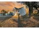 Charming two-story home with a covered porch and well-maintained front yard at sunset at 3213 Great Egret Dr, Johns Island, SC 29455
